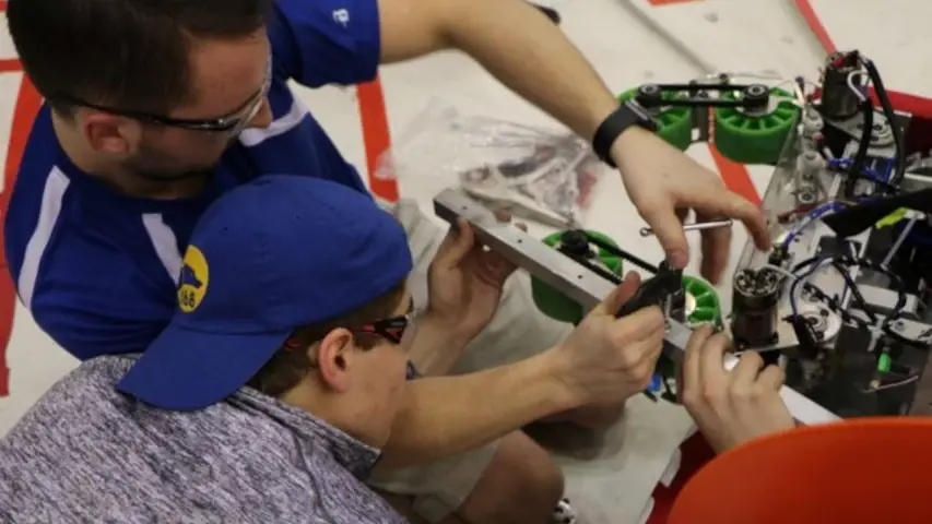 Fixing the crate intake on the robot between matches.