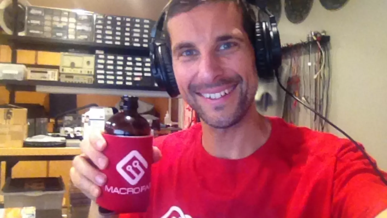 Figure 1: Joe Grand showing off some MacroFab swag in what looks like his electronics lab!