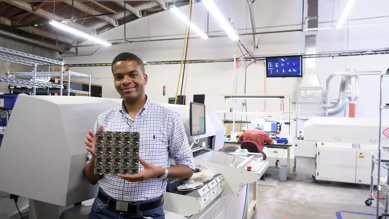 Figure 1: Kwabena of OpenMV holding up an OpenMV panel.